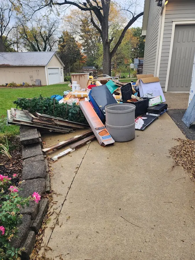 Dumpster being loaded with debris for Estate Cleanout Dumpster Rental in Concord
